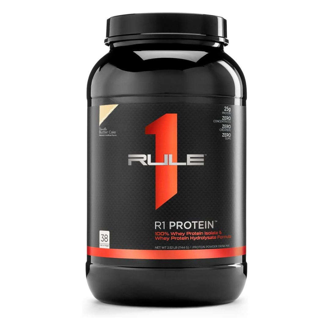 A black plastic tub of R1 Protein Whey Isolate powder on a clean white background. The label features a prominent red and white '1 RULE' logo with red and white text detailing the product as 100% Whey Protein Isolate.
